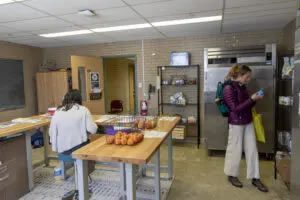 A Western student selects food from the hub’s dry goods shelf.